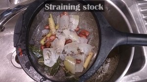 Straining the rooster soup stock.jpg