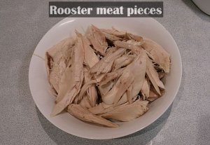 shredding the rooster meat from the bones.jpg